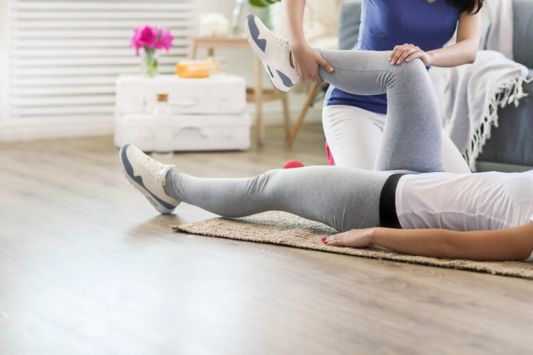 Woman is getting physical therapy from a professional doctor